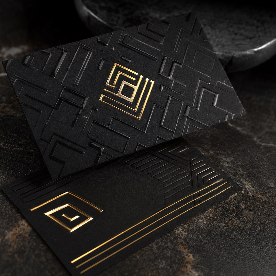 Luxury black business cards with embossed details and gold spot finish
